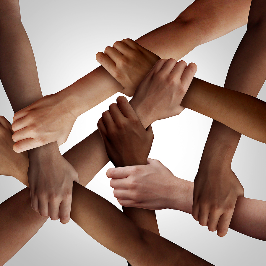 diverse group of interlocking hands