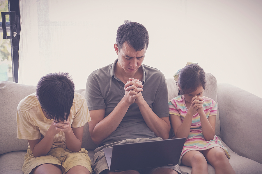 children and father praying